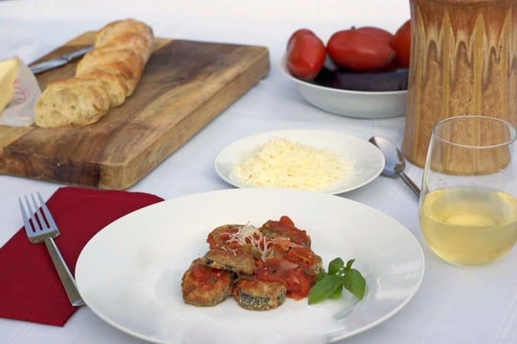 A plate of food on a table with a loaf of bread