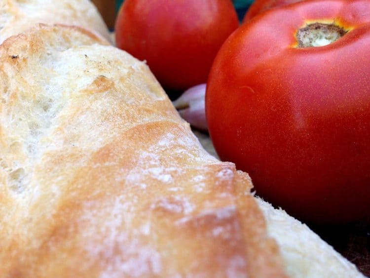 A loaf of bread with tomatoes.