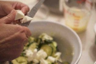 A person shredding cheese.