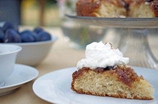 a slice of plum cake with whipped cream