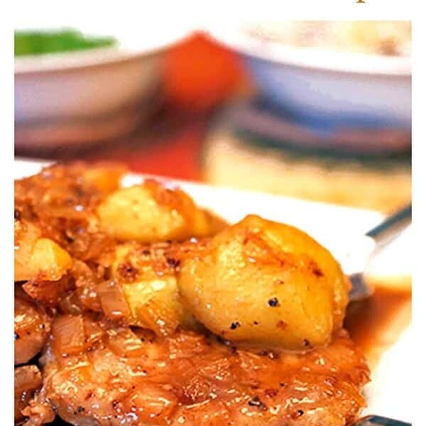 Plated pork chop and sauce with vegetables