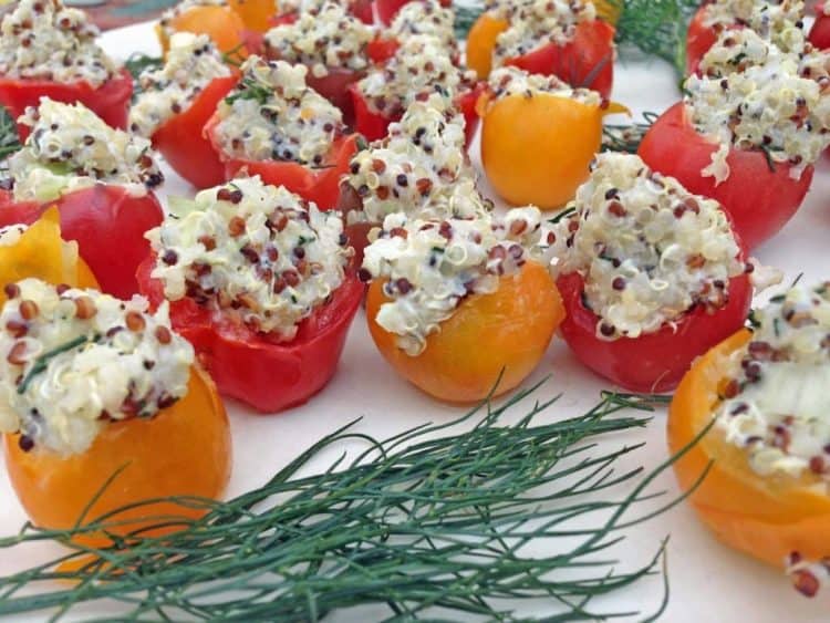 Food on a table, with stuffed cherry tomatoes.