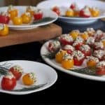 A table with plates of stuffed Cherry tomato.
