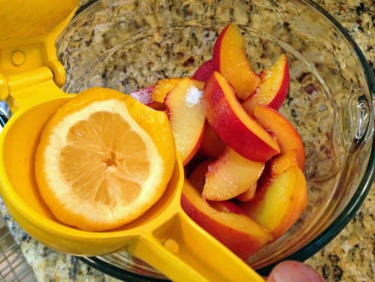 A bowl of fruit with lemon.