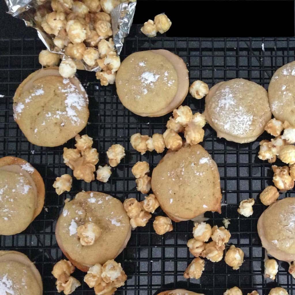 A bunch of whoopie pies and caramel corn on a rack