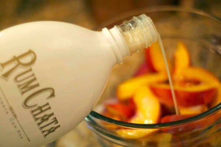 A close up of rum chata pouring into a bowl.