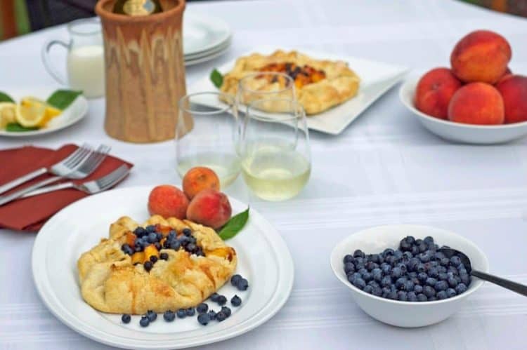 A table topped with plates of fruit tart.