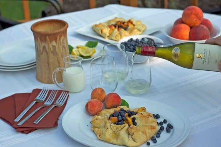 A table topped with plates of fruit tart.