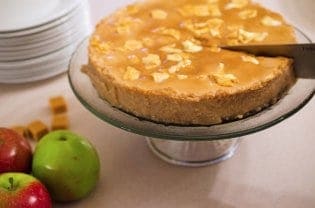 A piece of cheesecake being cut.