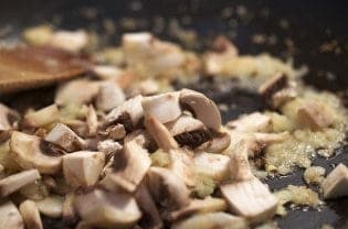 A close up of mushrooms in a pan.