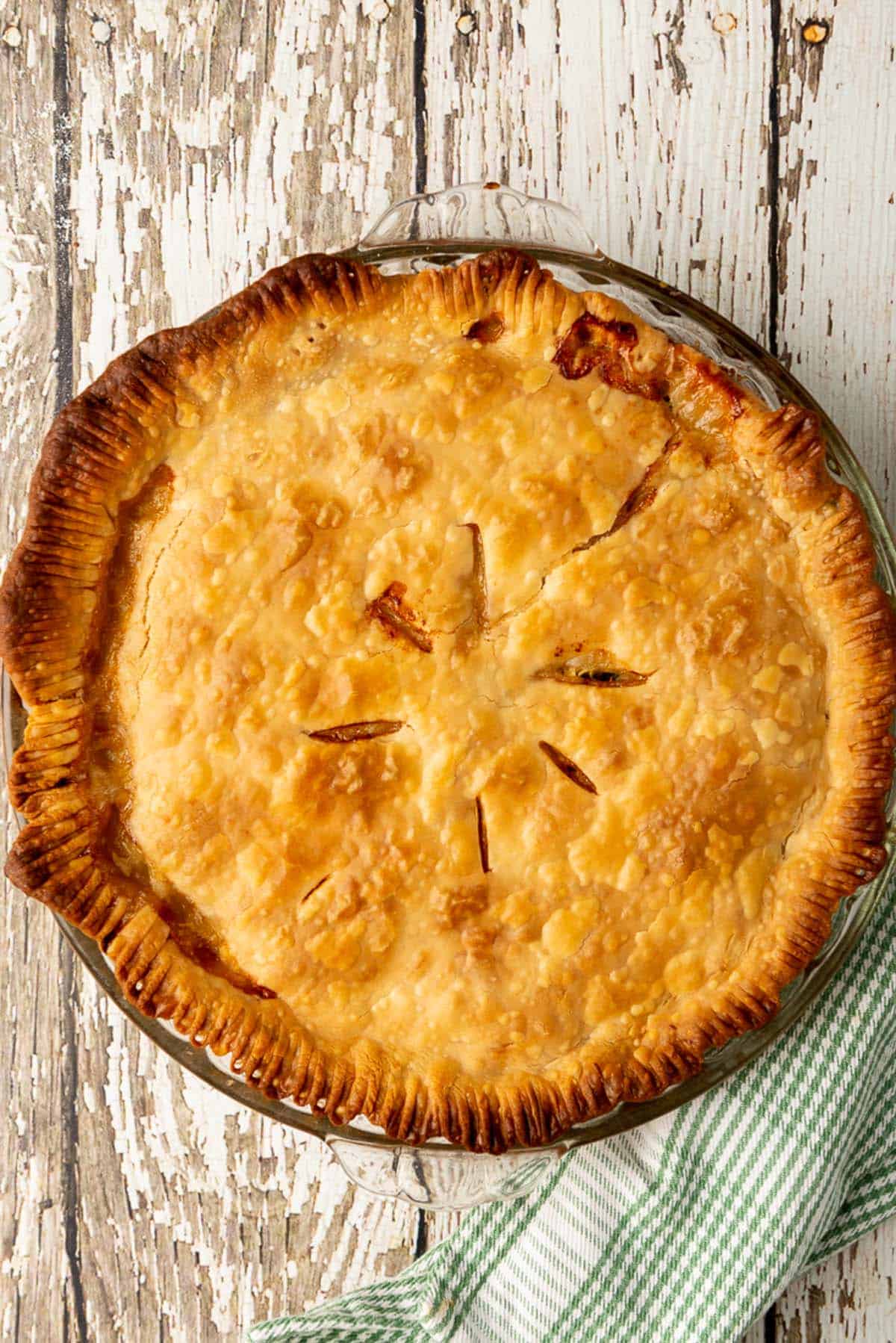 A golden brown whole and uncut chicken pot pie fresh from the oven.