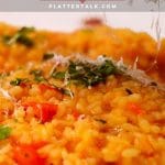 DIsh of tomato risotto with parmesan cheese.