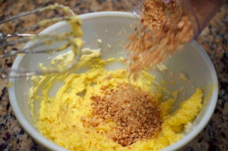 Hazelnuts being poured into a bowl.