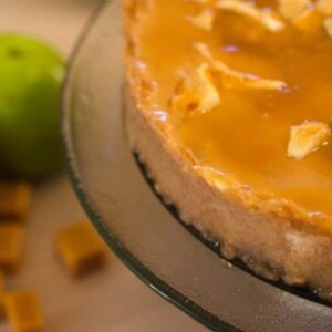 A close up of a caramel apple cheesecake.