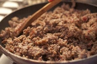 A close up of meat in a pan.