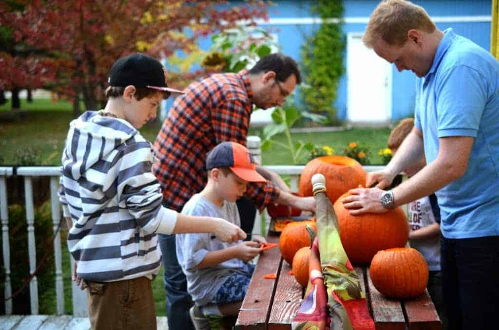 A group of people carving pumpkins.