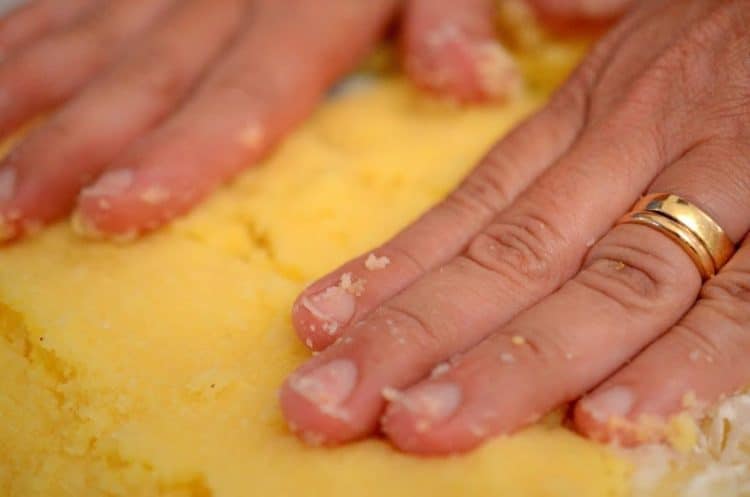 A pair of hands working some dough.