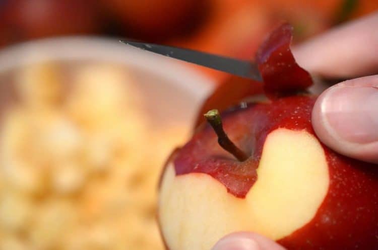 a person peeling an apple