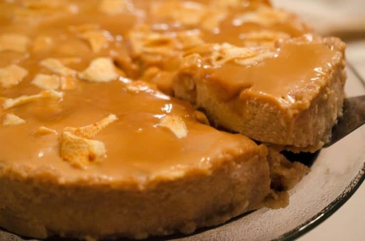 A close up of a piece of caramel apple cheesecake.