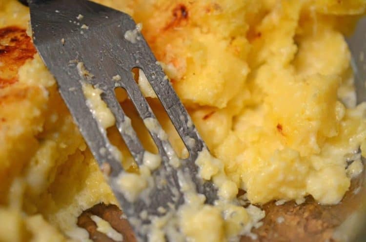 Polenta on a plate with a fork.