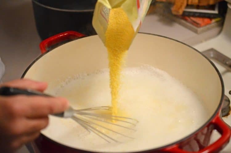 Pouring polenta into a pot.