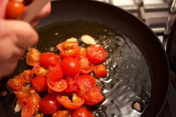 A pan filled with tomatoes and oil.