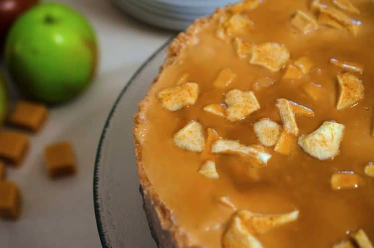 A cheesecake on a serving platter.