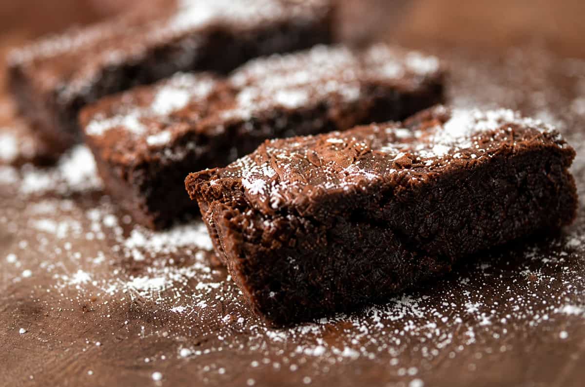 Some brownies with powdered sugar.