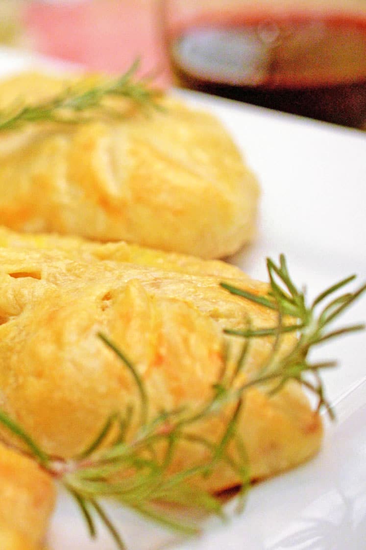 Serving of pork wellington garnished with fresh rosemary