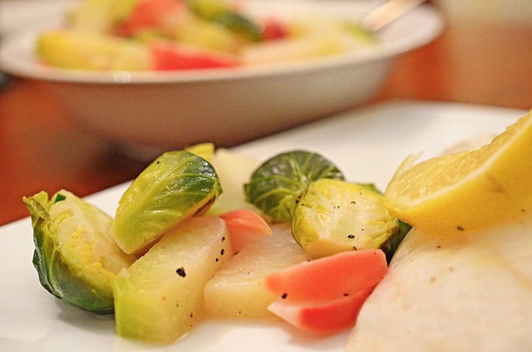 A plate of food on a table, with Brussels sprouts