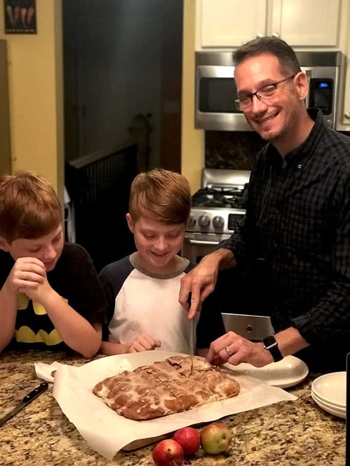 2 kids watching adult cutting apple bars