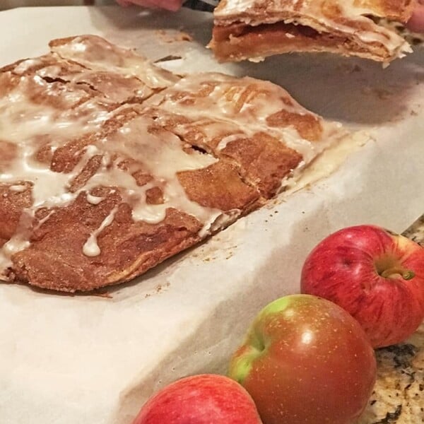 Cut apple bars on parchment with apples