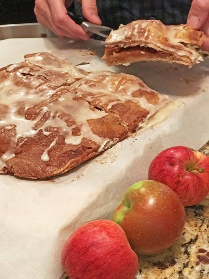 Glazed apple bar dessert being served whole red apples in foreground