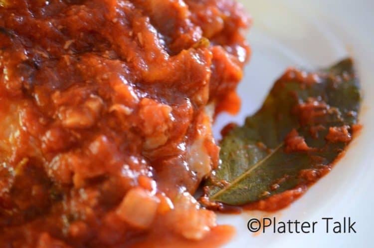 A close up of food on a plate, with chicken Cacciatore.