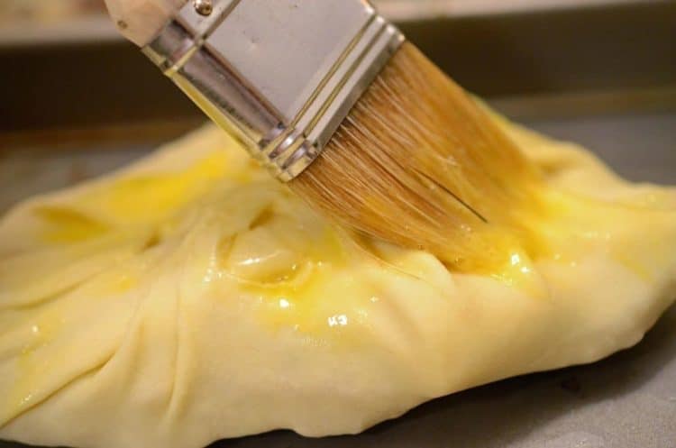 Brushing an egg wash on pastry