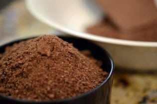 A close up of a bowl of cocoa powder.