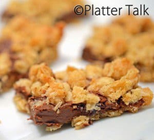 A close up of a plate of food, with oatmeal bars.