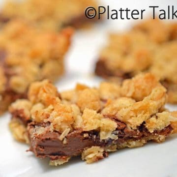 A close up of a plate of food, with oatmeal bars.