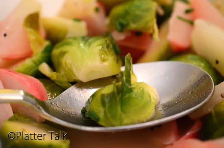 Tablespoon holding braised vegetables.