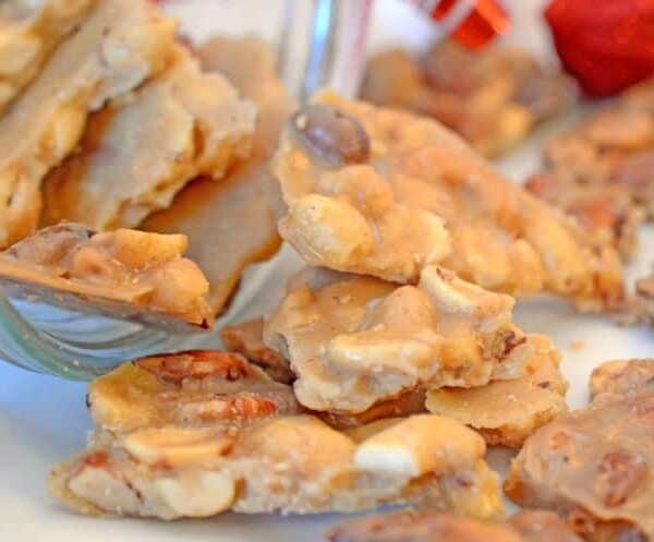 A close up of a plate of peanut brittle.