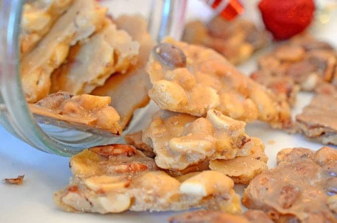 A close up of a plate of peanut brittle.