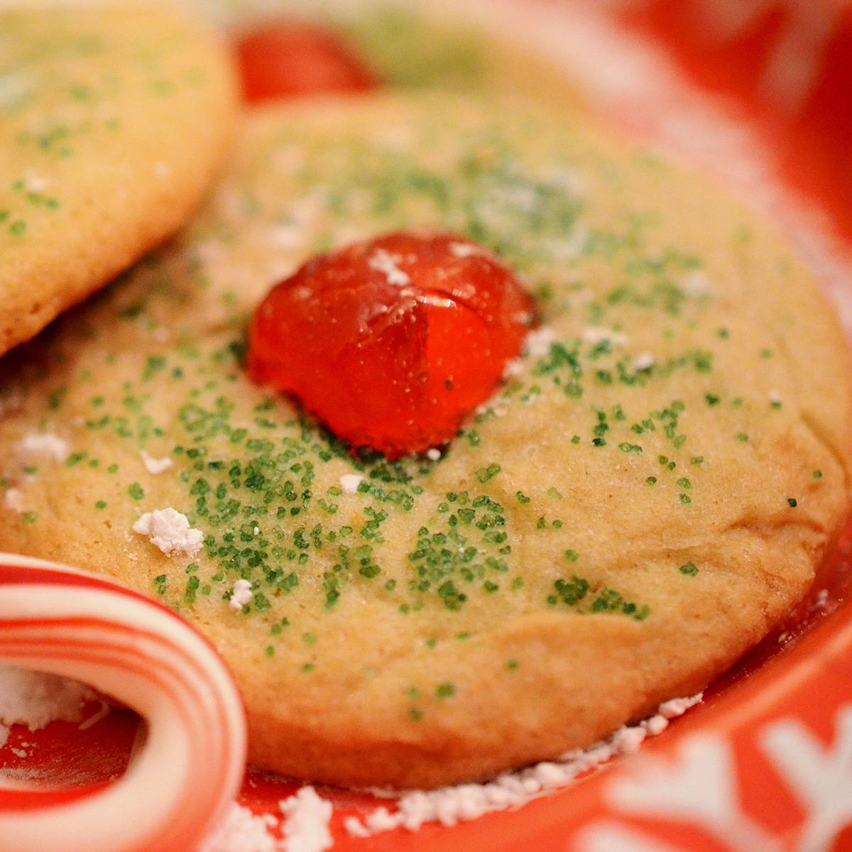 A Christmas cookie with cherry in the middle