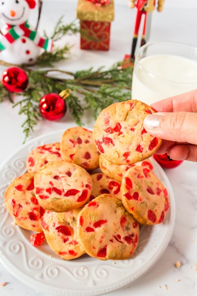 Picking up a baked Christmas cookie.