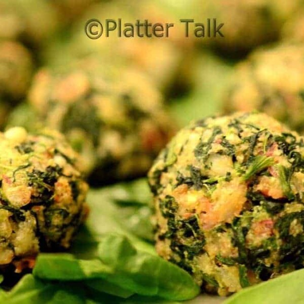 A close up of a few bacon spinach balls.