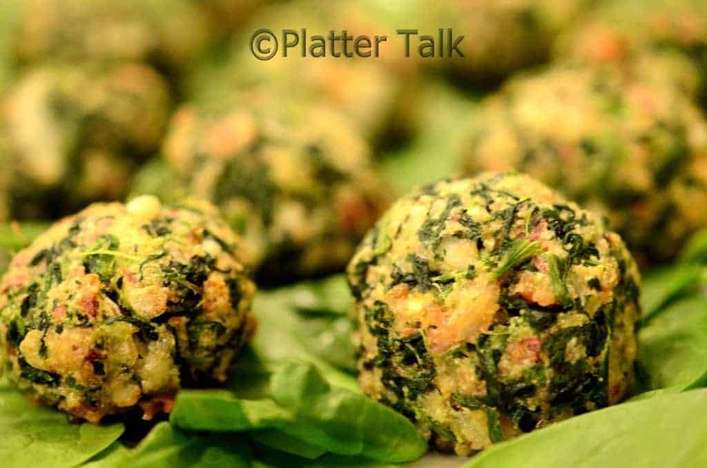 A close up of a few bacon spinach balls.