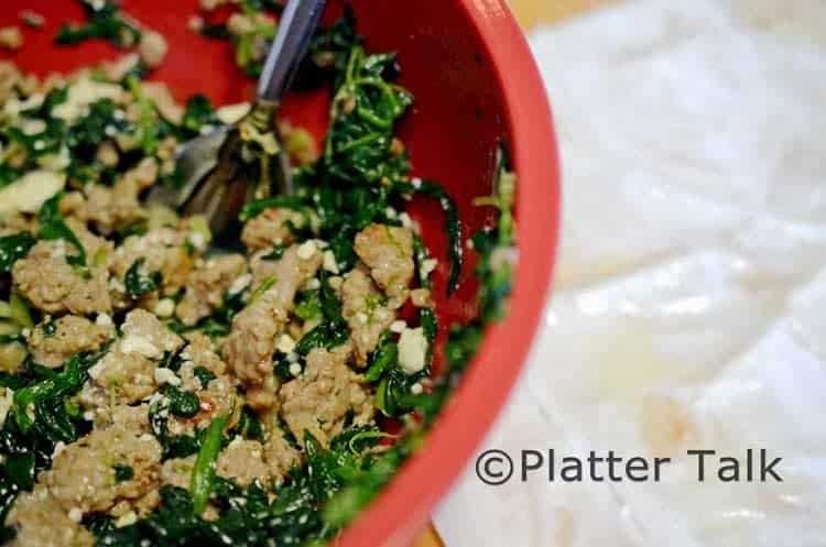 A bowl of food with broccoli, with meat and spinach.