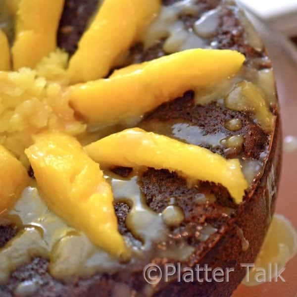 a ginger cake with mango and brandy glaze on a stand