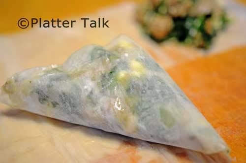 A close up of food on a table, with Spanakopita.