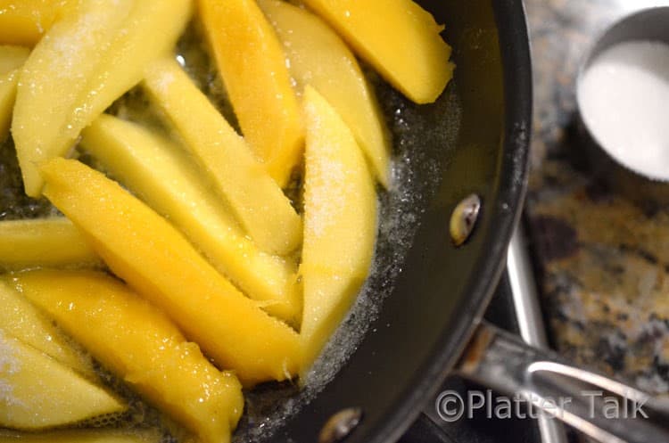 slices of mango in a pan