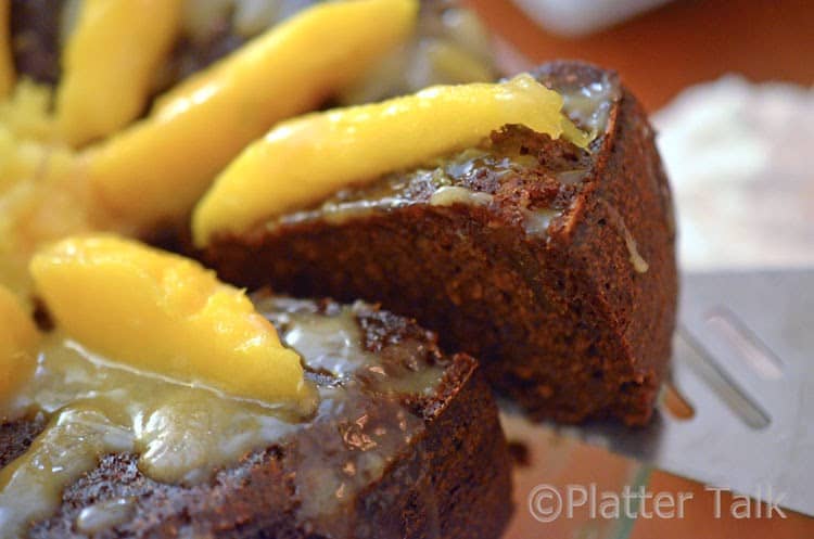 a close up of a ginger cake with mango and brandy glaze